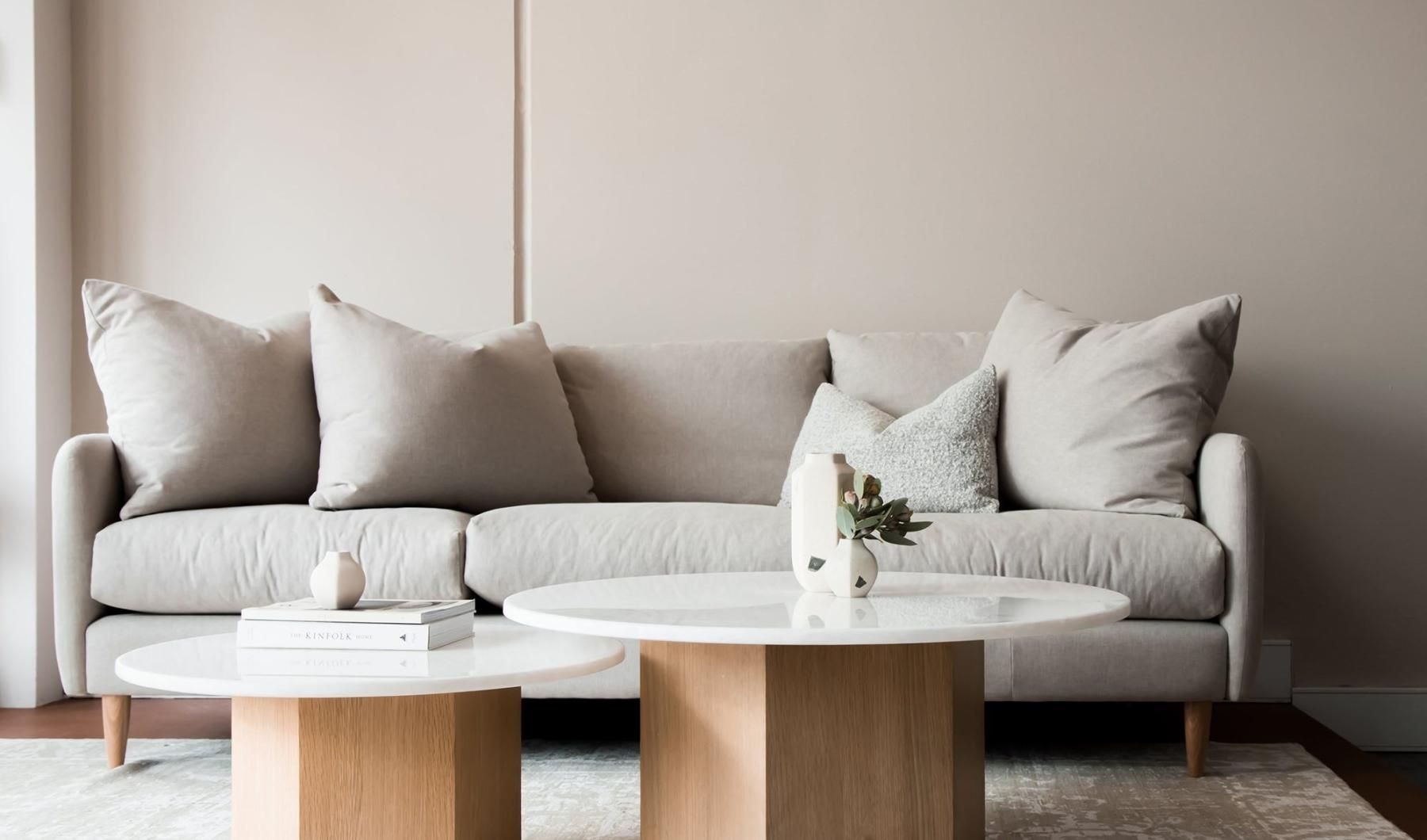 A white couch with a coffee table
